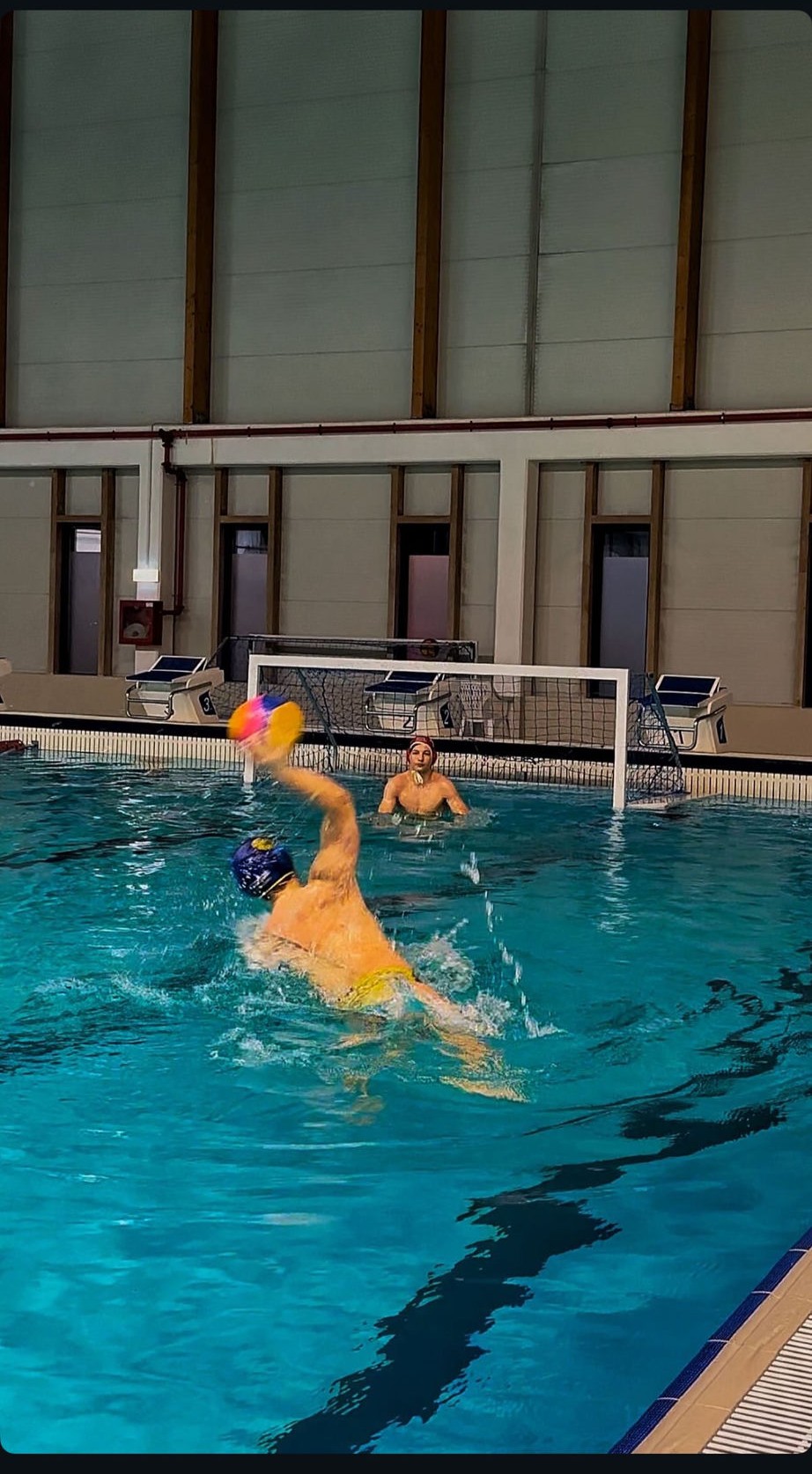 Marius playing water polo, shooting on goal